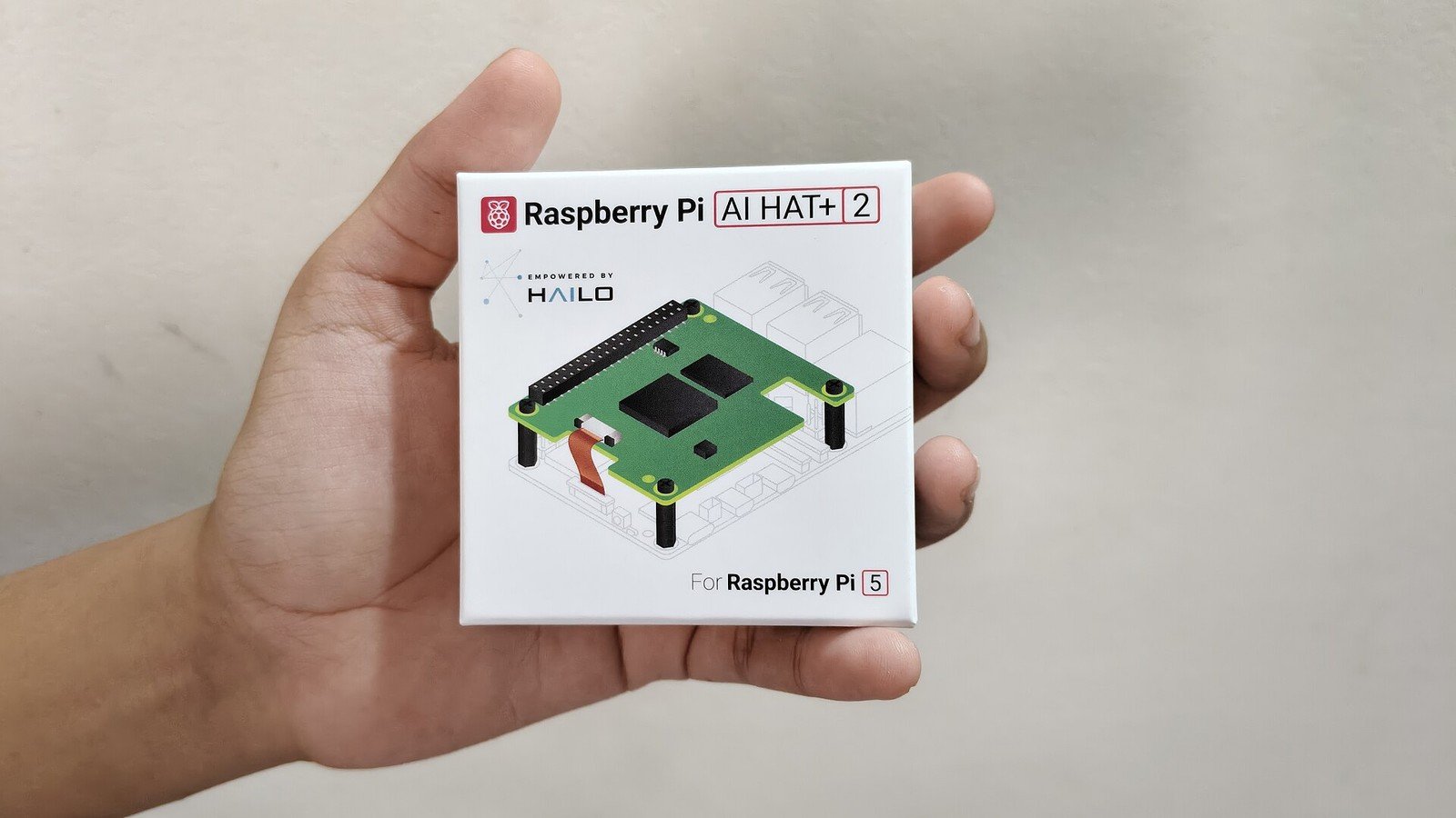 Raspberry Pi AI HAT+ 2 retail box showing the add-on board for Raspberry Pi 5.