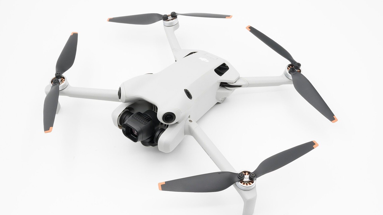 Close-up photo of a DJI Mini 4 Pro quadcopter on a white background.
