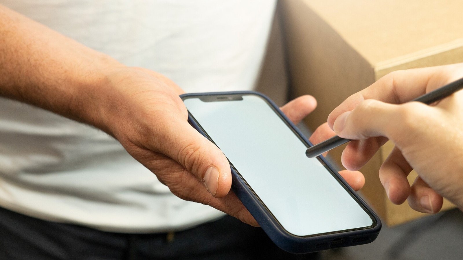A person confirming a delivery on a phone, illustrating private information on a mobile device.