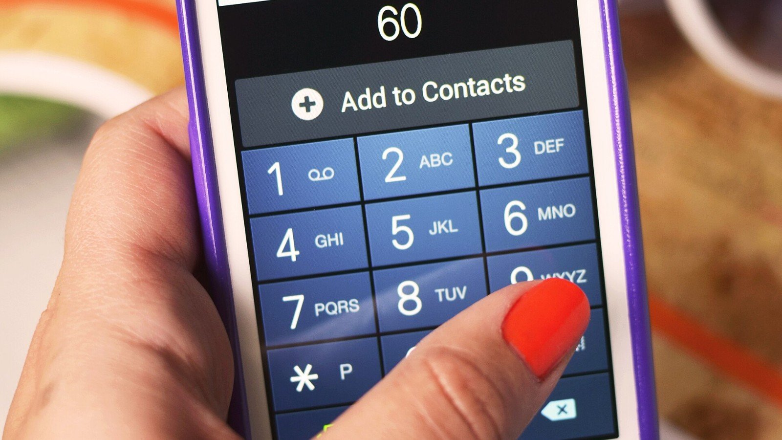 A hand holding a smartphone, representing passkey sign-in on a personal device.