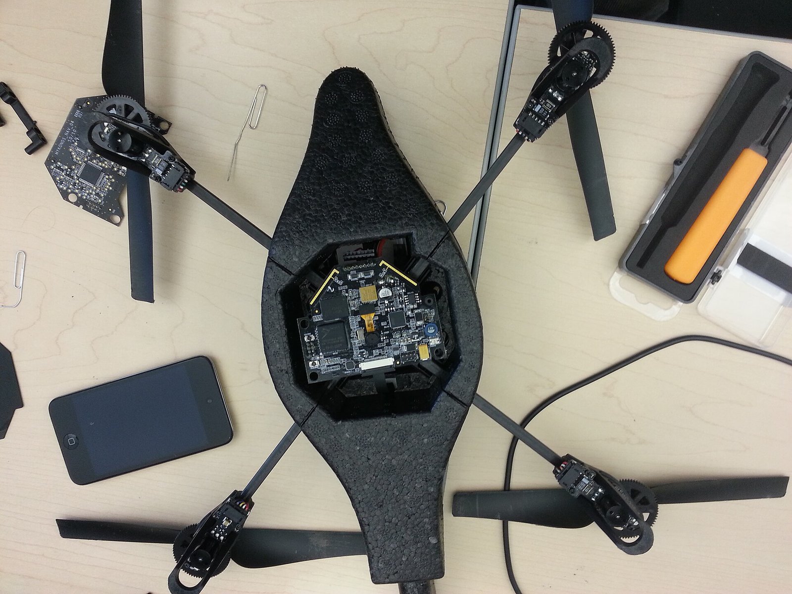 Quadcopter with its lower enclosure removed to show internal components.